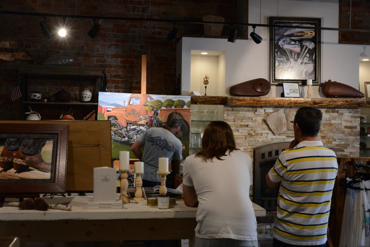 customers watching Scott paint in his Deadwood Gallery