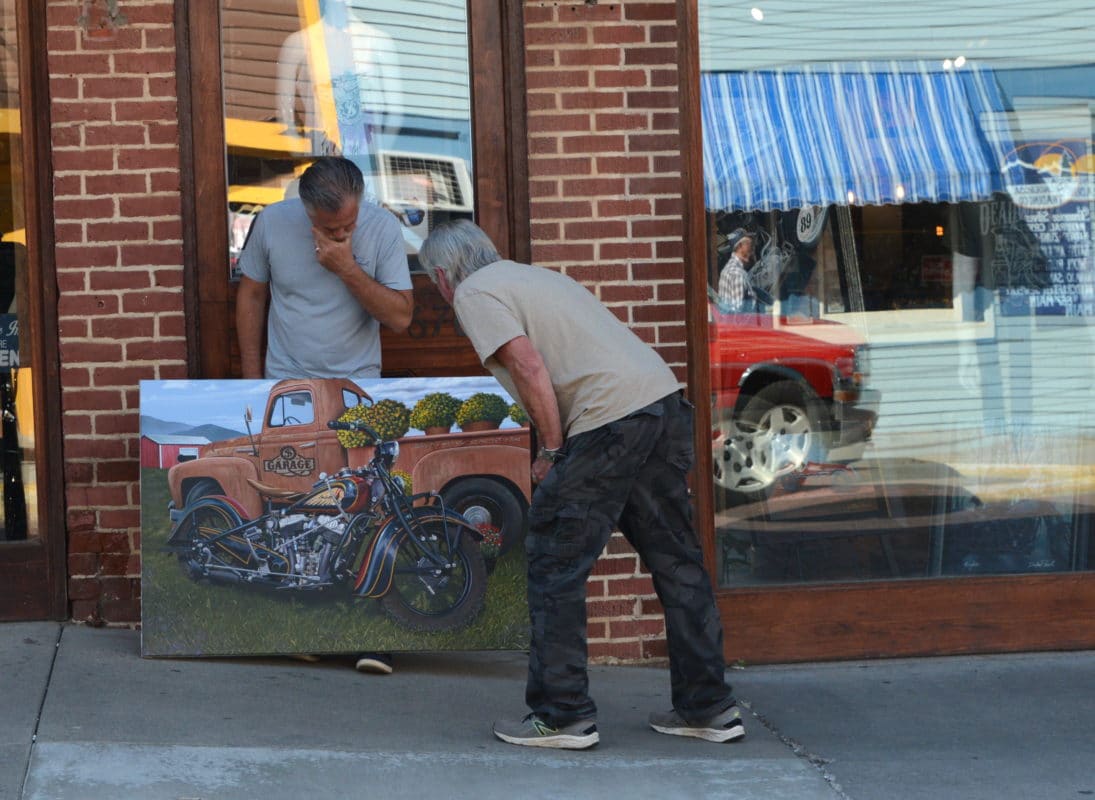 admirer looking at the Sturgis Motorcycle Rally Painting by scott jacobs