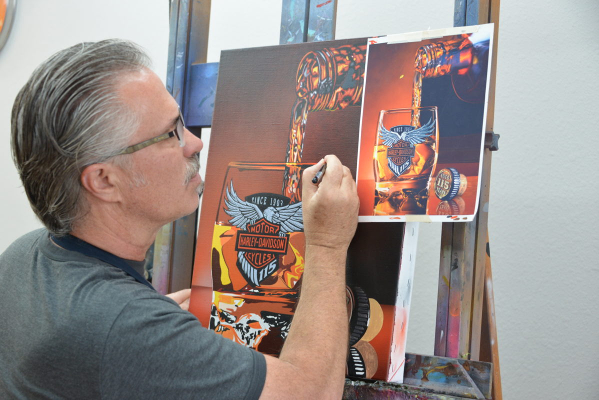 scott working on the 115th anniversary painting for harley