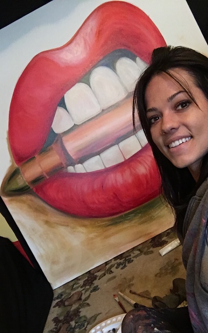 Alexa Jacobs working on her bullet and lips painting called Bite Me