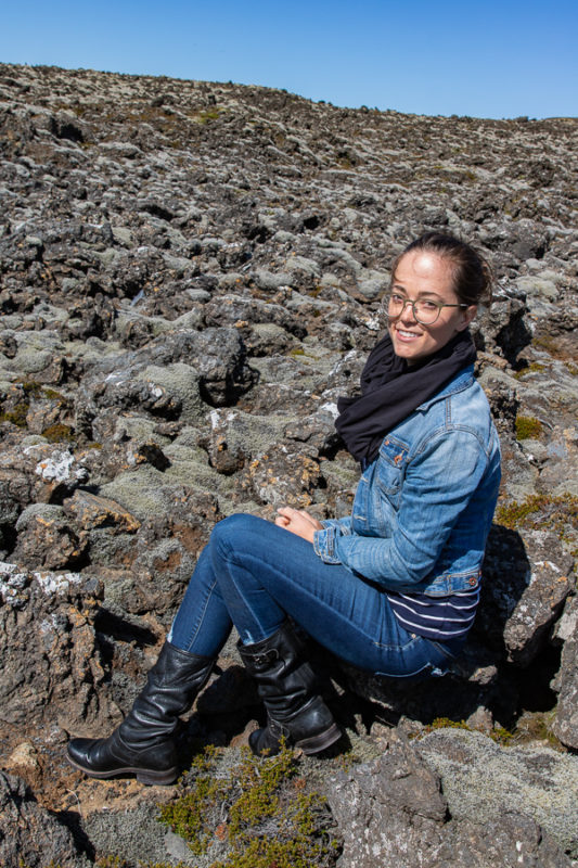 Olivia sitting on lava rock in Iceland