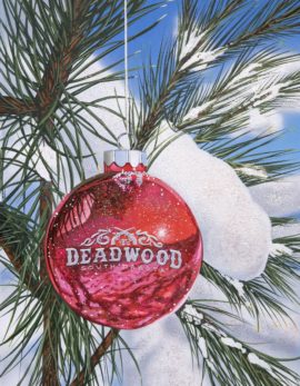 painting of a red ornament in a snowy tree by scott jacobs called "Hangin in Deadwood"