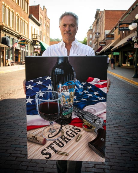 scott jacobs holding his sturgis rally painting, photo by olivia jacobs