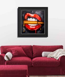 painting by alexa jacobs of lips and teeth biting a gold bullet hanging in a home