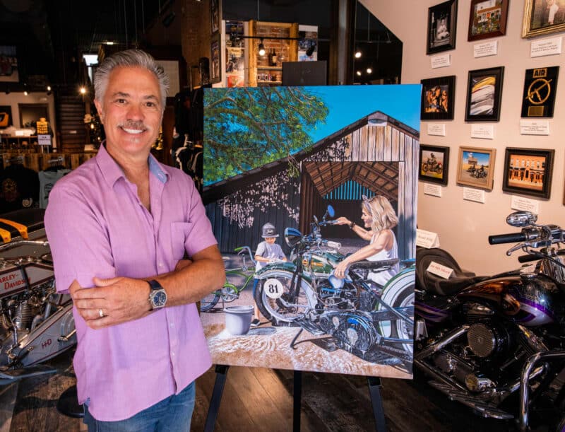 Scott Jacobs and his motorcycle painting called moments like these of a mother and son washing a motorcycle