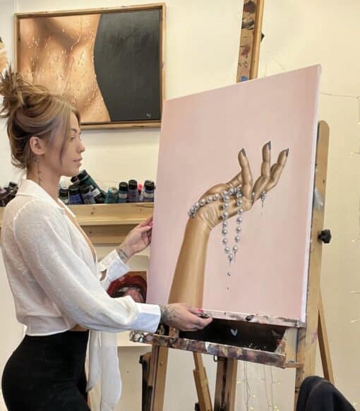 alexa with her contemporary painting of a hand holding a pearl necklace