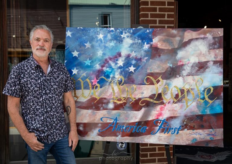 Scott Jacobs with his completed patriotic painting, America first