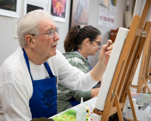 student painting during the 2024 artist retreat class