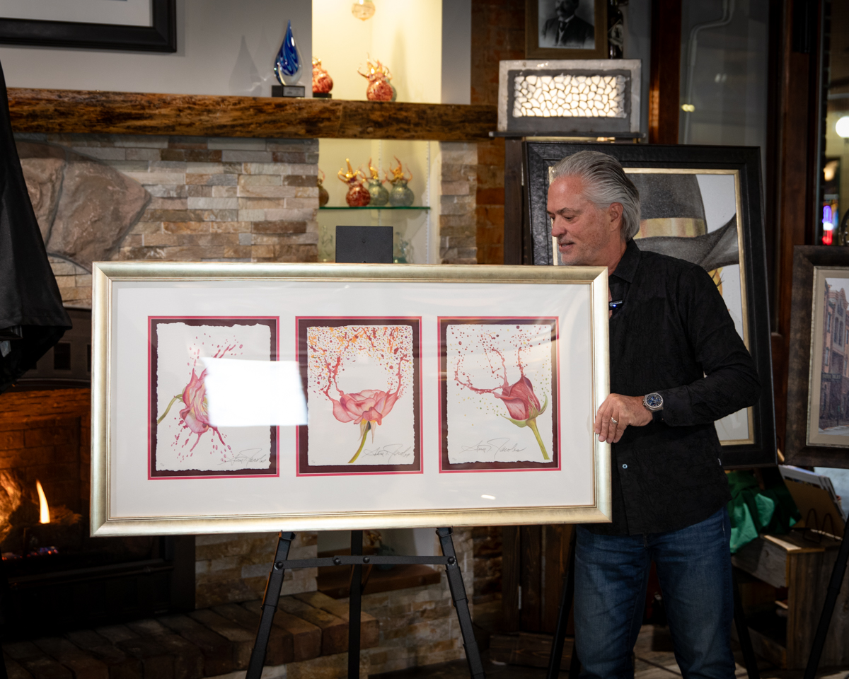 photo of Scott Jacobs presenting his flower painting "Floral Reconstruction"