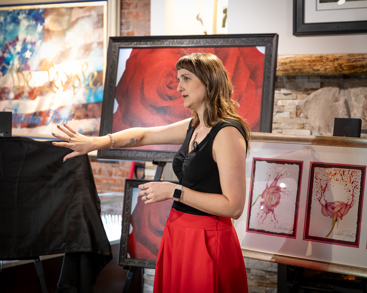 photo of Jacqueline Rinehart presenting her painting scarlet delight