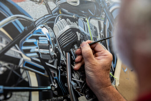 Scott Jacobs painting the engine of his 2025 Sturgis rally motorcycle painting