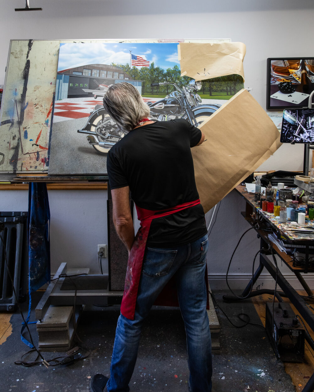 full photo of Scott jacobs at his drafting table painting his 2025 Sturgis rally painting
