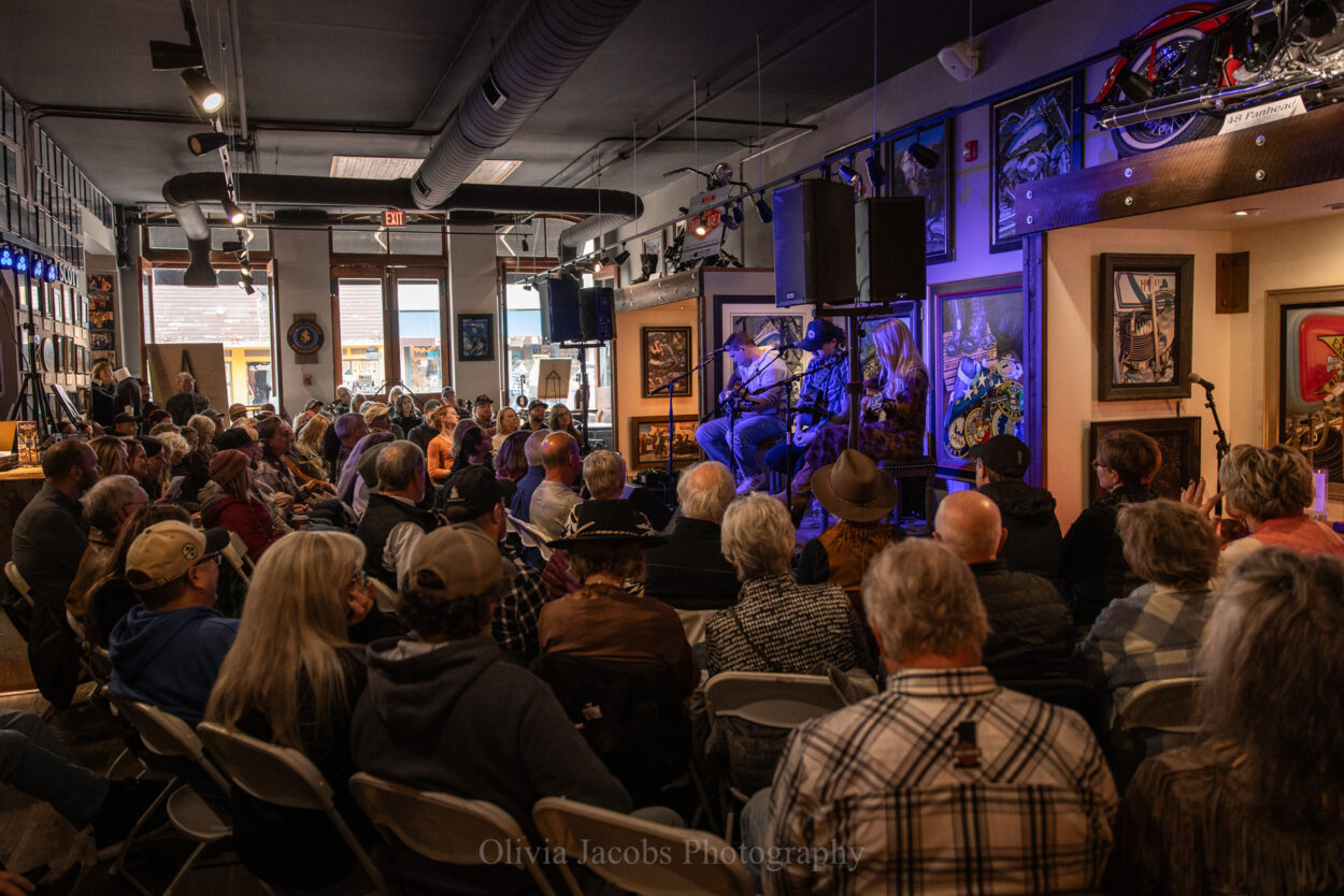 photo by Olivia Jacobs of the crowds listening to live music in Jacobs Gallery Deadwood