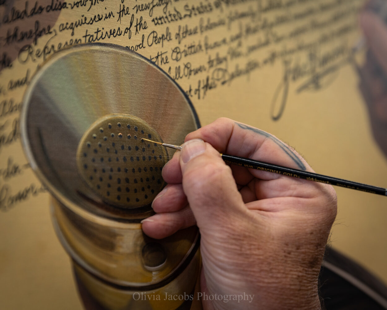 Scott Jacobs painting the pounce pot in America's 250th anniversary painting