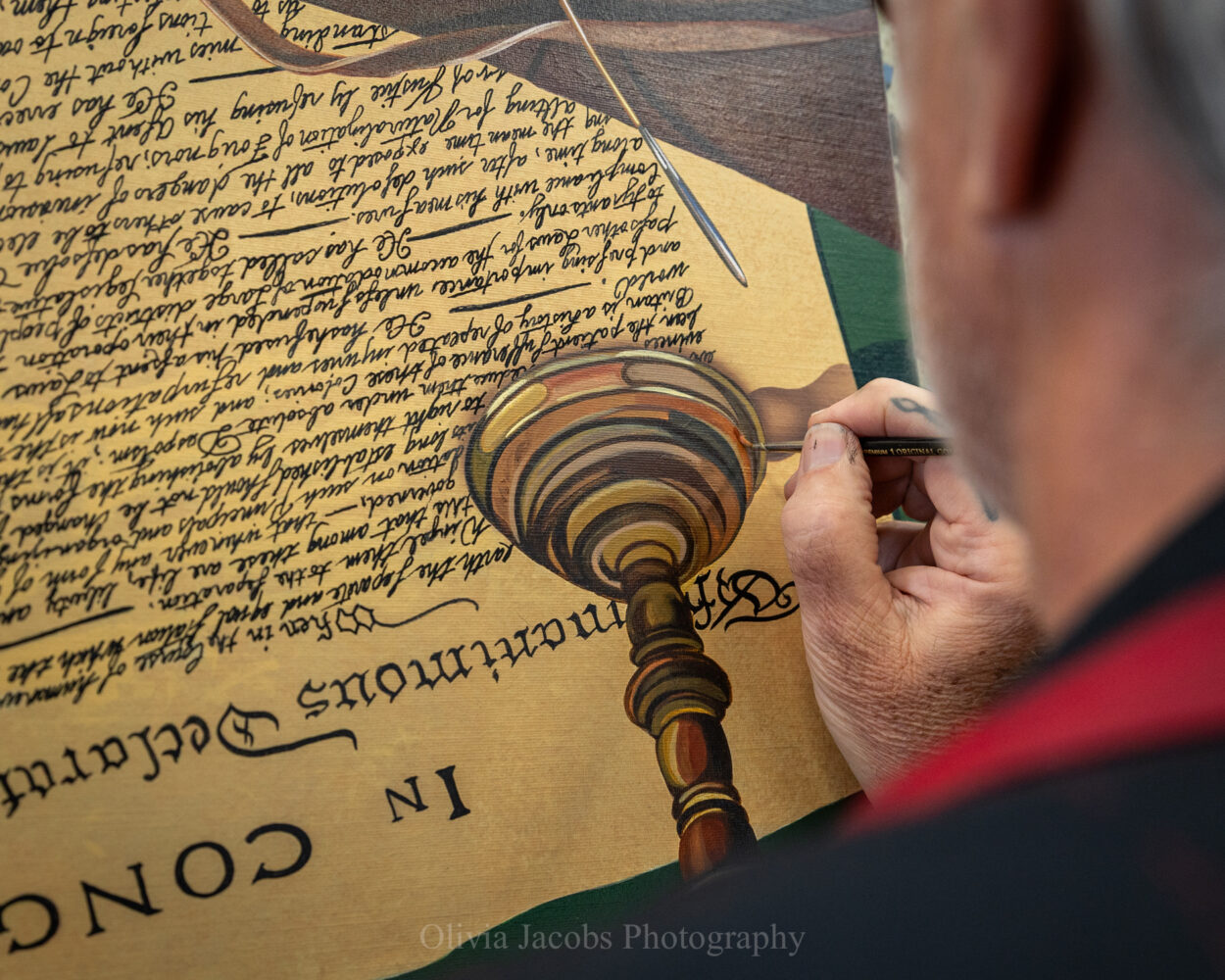 Scott Jacobs painting the lettering on the declaration of independence